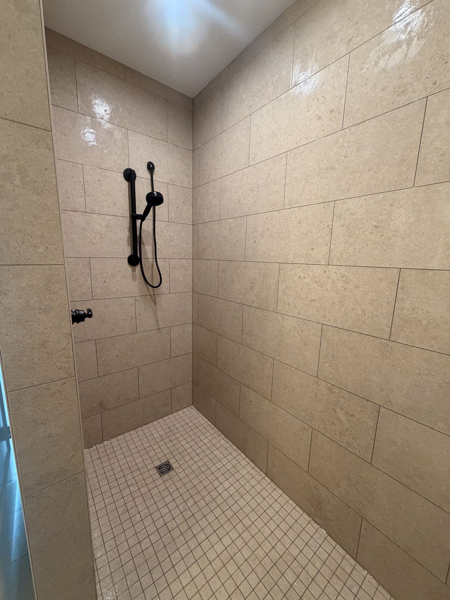 Walk-in tiled shower with a linear drain