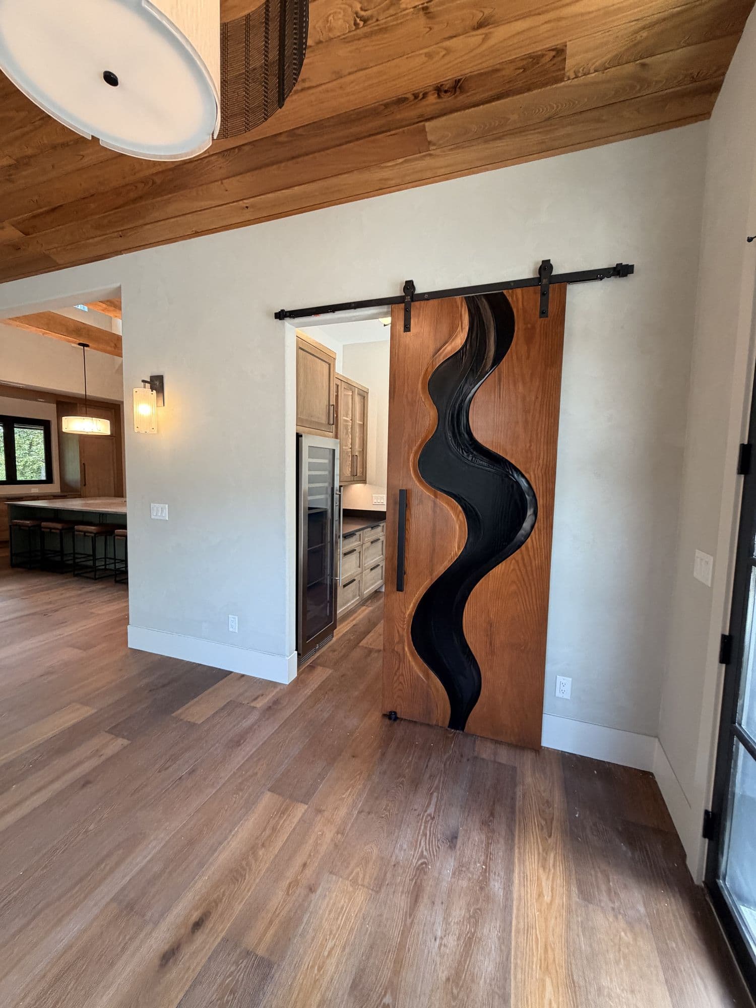 Hallway with a carved live-edge sliding barn door