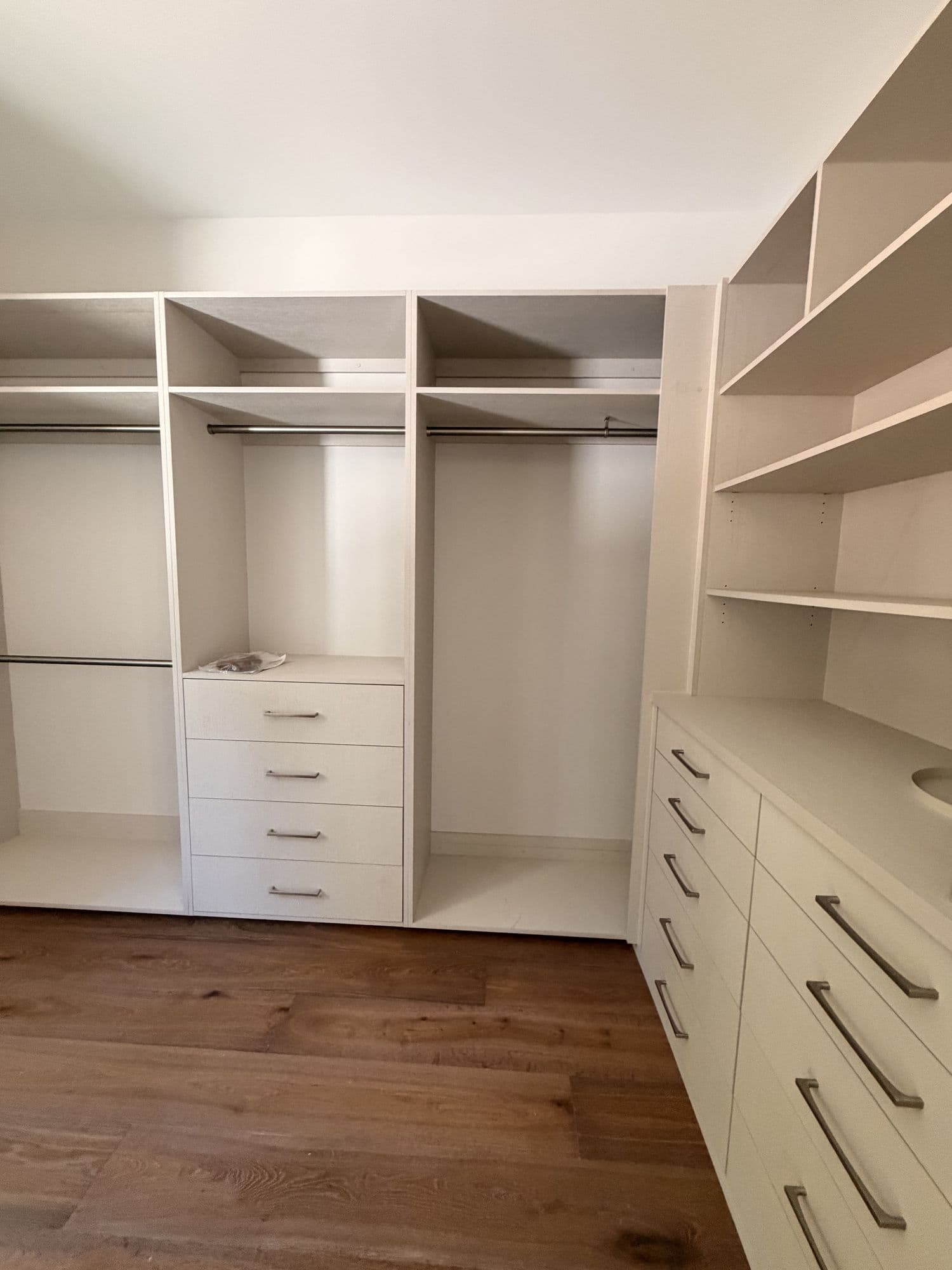 Walk-in closet with built-in shelving and drawers