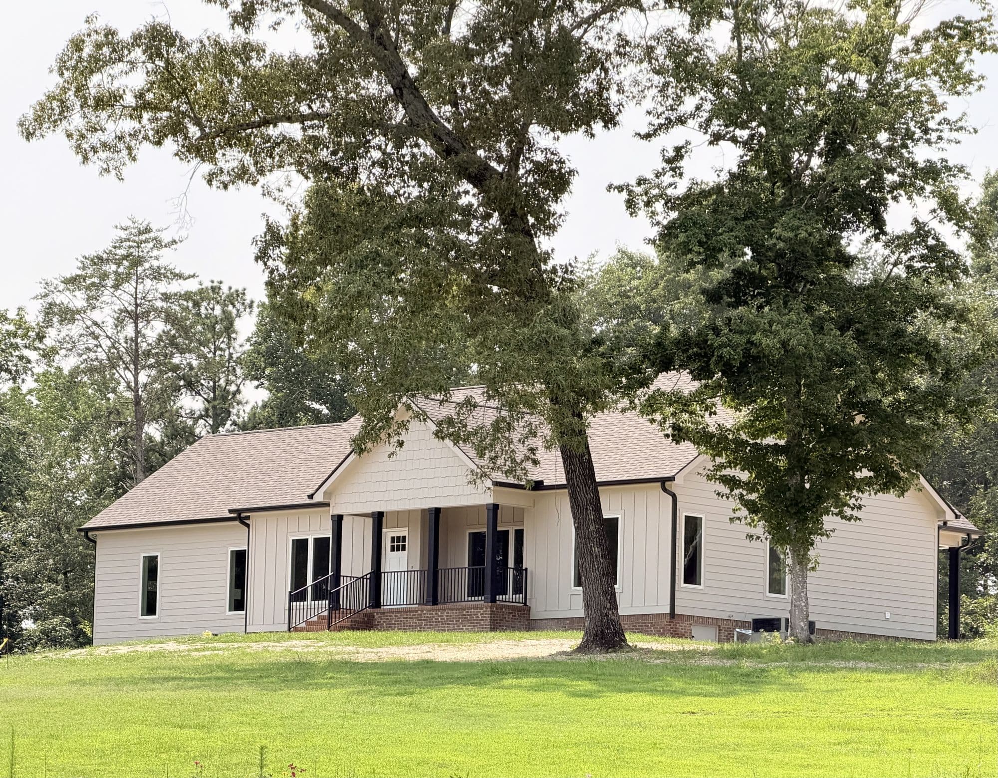 White farmhouse under a mature oak