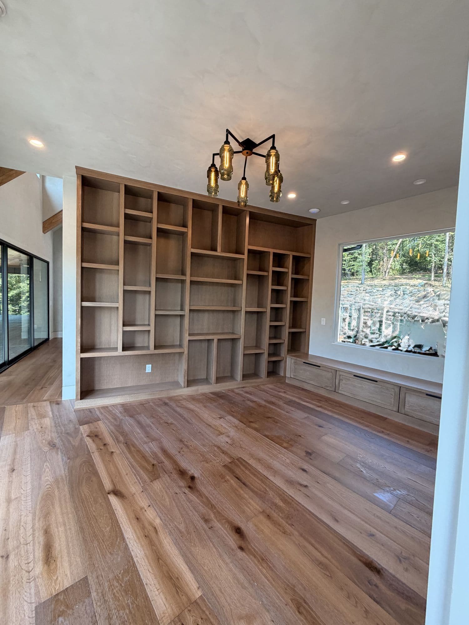 Built-in shelving wall in a room with wood floors