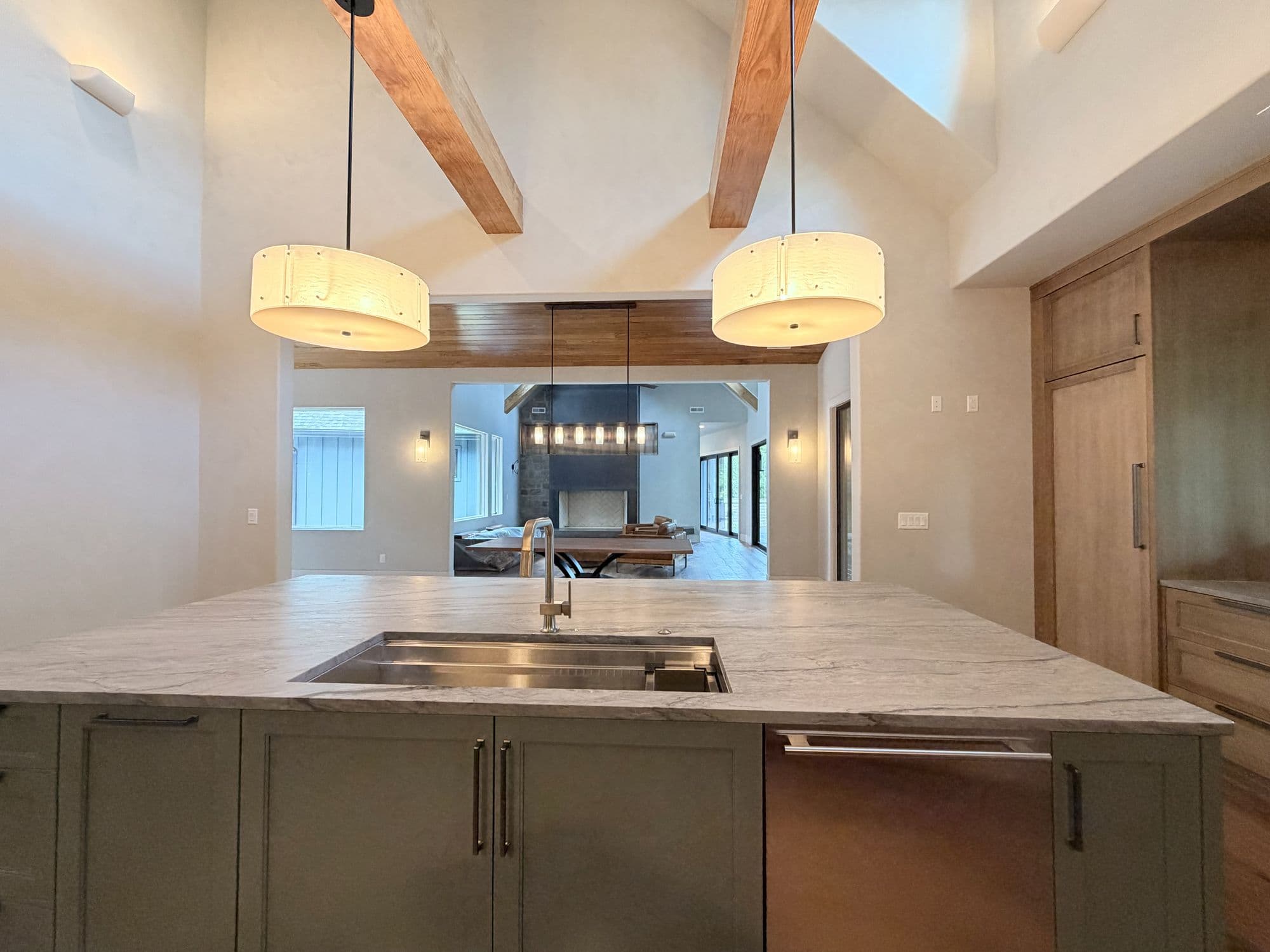 Kitchen island with drum pendants and exposed beams