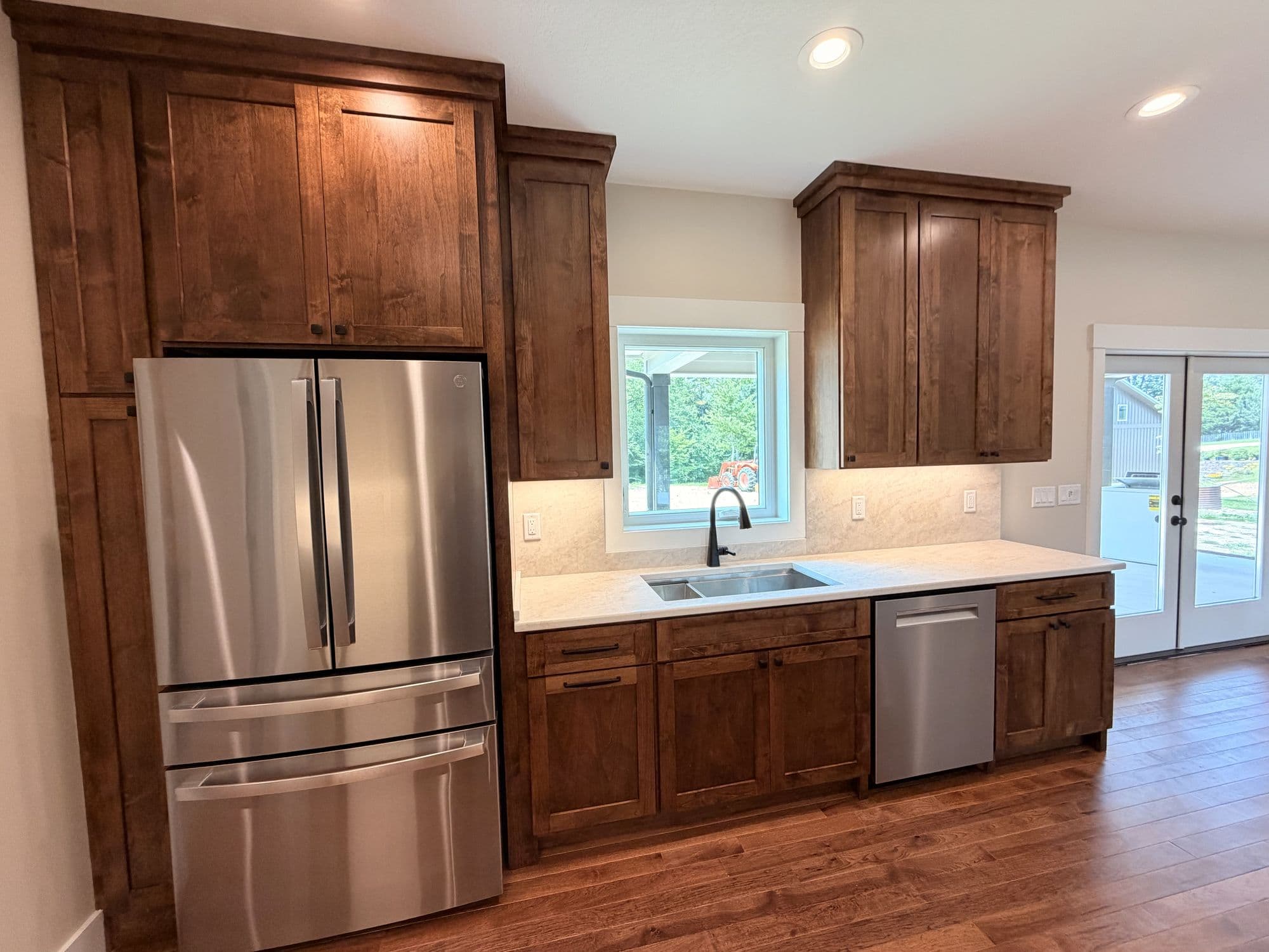 Kitchen with stained cabinetry and stainless appliances
