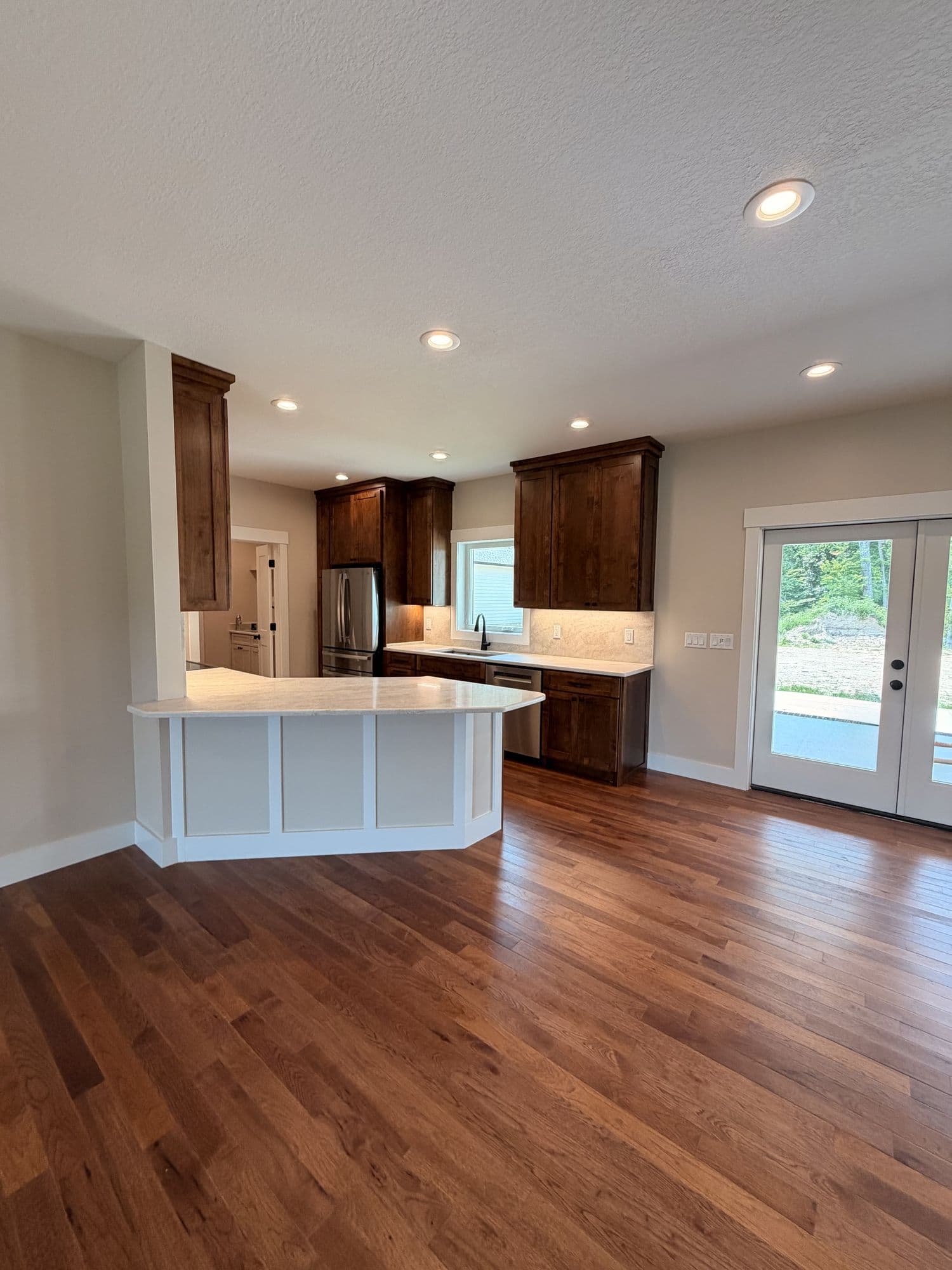 Kitchen opening onto a living area in white oak